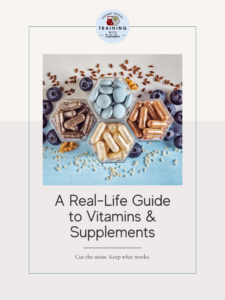 Wellness guide cover with the title “A Real-Life Guide to Vitamins & Supplements” and subtitle “Cut the noise. Keep what works,” showing neatly arranged supplement capsules and tablets in hexagon dishes, styled with blueberries, seeds, and nuts to represent a balanced, real-food approach to nutrition.